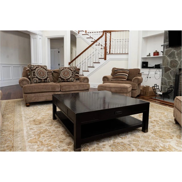 Kravet's large square bi-level coffee table finished in ebony on square straight legs with two large storage drawers,...