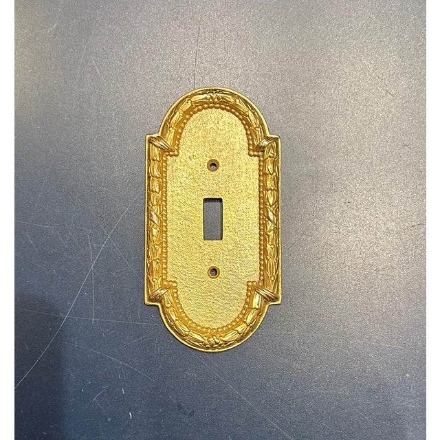 Set of 9 Sherle Wagner Acanthus Single Switch Plates, Burnished Gold Finish.