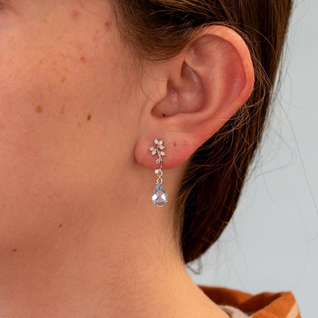 Soft sea-blue aquamarines drop gracefully from a sparkle of lab grown diamonds in these pear-shaped earrings, set in solid...