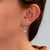 Soft sea-blue aquamarines drop gracefully from a sparkle of lab grown diamonds in these pear-shaped earrings, set in solid...