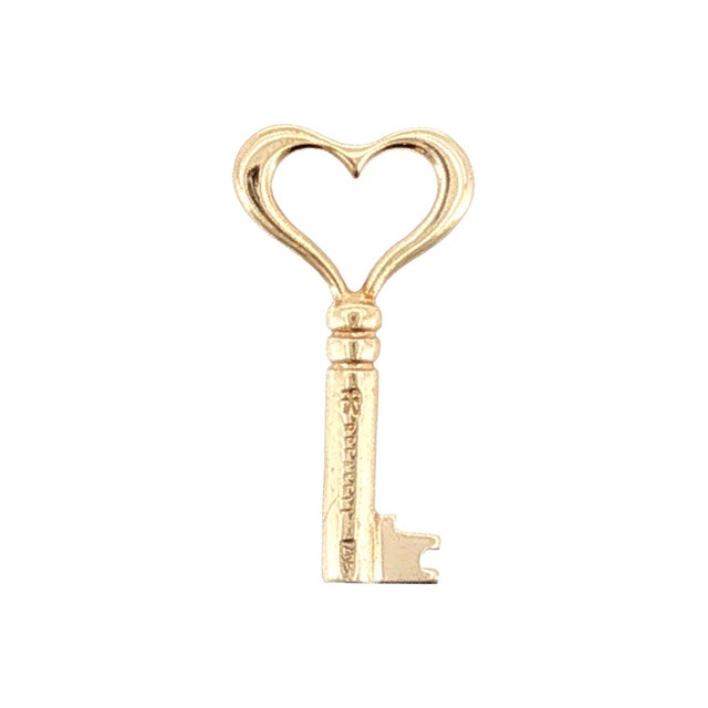 A late-20th-century 14k gold pendant with a heart-shaped key design made by J.H. Breakell & Co. in Newport, Rhode Island....