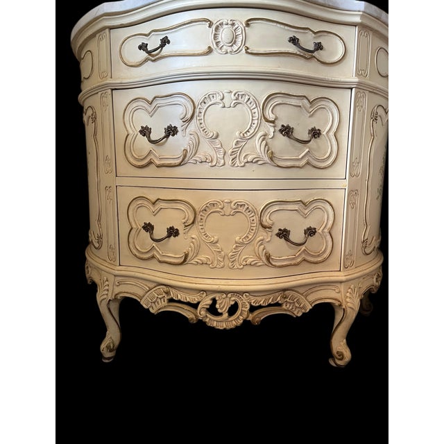 The ornate carvings, curved shape, and the use of a marble top are all characteristic of the French Rococo (Louis XV)...