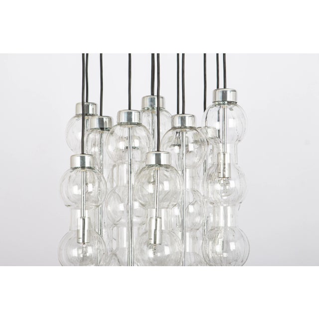 A special large cascading chandelier by doria, manufactured in germany, circa the 1970s with 13 murano glasses. Wonderful...