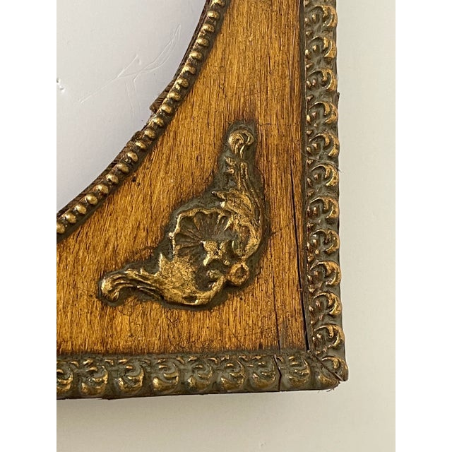 Vintage gold frame with oval profile.