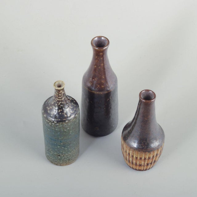 Wallåkra Ceramics, Sweden. Three small ceramic vases. Organically shaped vases in wheel-thrown stoneware with raw surfaces...