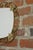 Oval mirror from the 50s and 60s; brass structure with scrolls and foliage, all in excellent condition.