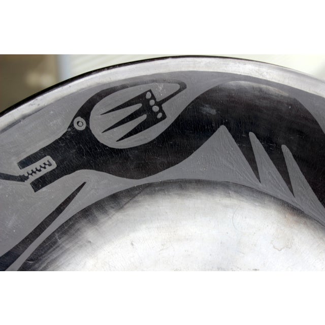 Black on black San Ildefonso pottery plate.with encircling serpent. Very traditional design. Signed on reverse Marie and...