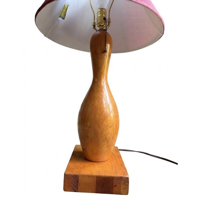 Artisan-crafted bowling pin lamp featuring a solid maple pedestal base and an original signed Dale Tiffany shade. A rare...