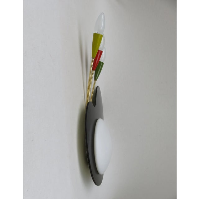 An unusual wall lamp in the form of a "painter's palette" from the 50s, made by the company Kaiser-Leuchten. The lamp has...