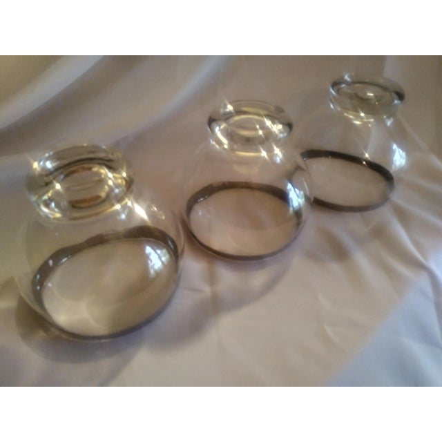 Trio of perfect Dorothy Thorpe style Coctail Glasses with the signature Silver rim. They feel as good while you are...