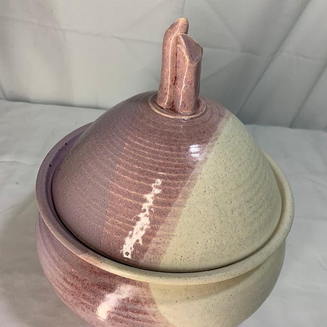 Offered here is a handcrafted ceramic lidded pot with a textured pink glaze and a unique sculptural finial. Features...