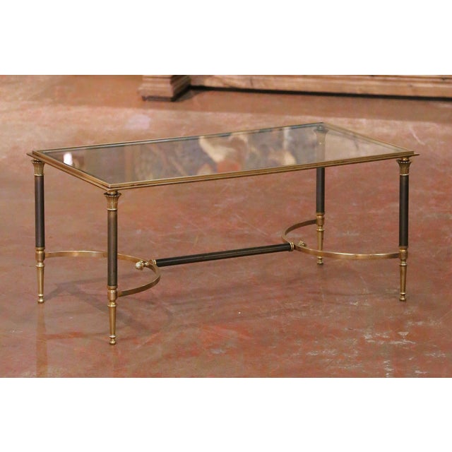 This elegant French coffee table by Maison Jansen was crafted circa 1960 and reflects the refined neoclassical aesthetic...