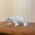 An elegant mid-century white glazed porcelain figurine depicting a polar bear mid-stride. This piece beautifully captures...