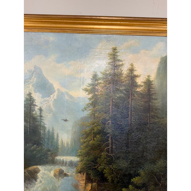 This painting is a 19th-century oil on canvas landscape featuring a dramatic waterfall cascading down a rocky...