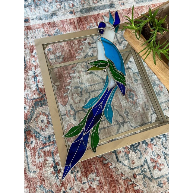 Bring a touch of tropical elegance to your home with this stunning stained glass parrot sun catcher. Crafted in the...