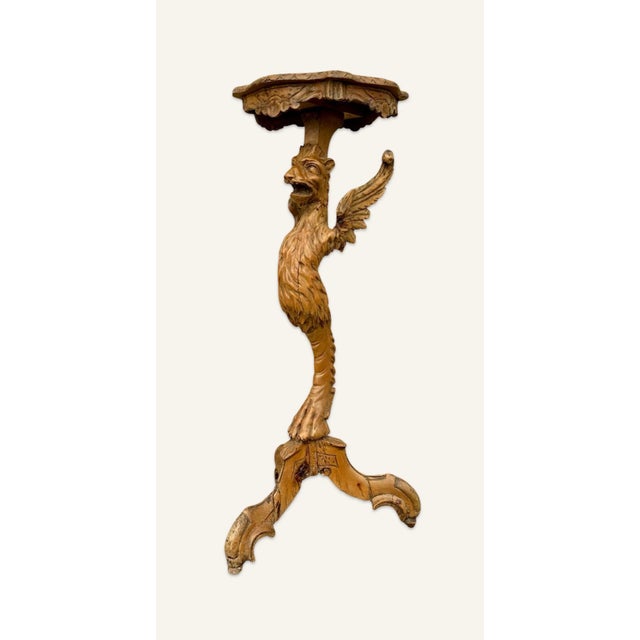 18th century pedestal in the form of griffon with a single foot supporting the top. Note the centuries old damage by...