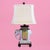 An Italian ceramic elephant table lamp, the elephant base hand-modeled and full of character beneath a classic shade line....