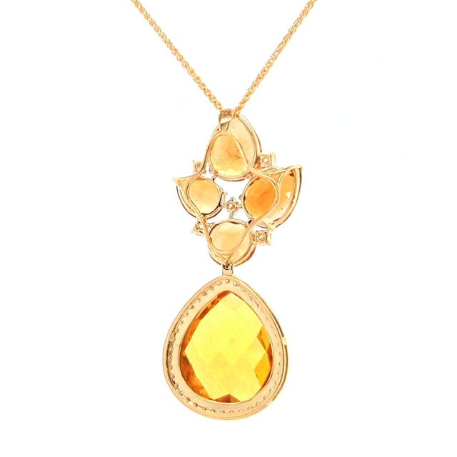 This pendant necklace showcases the radiant warmth of citrine, arranged in a thoughtful composition of varied cuts and...
