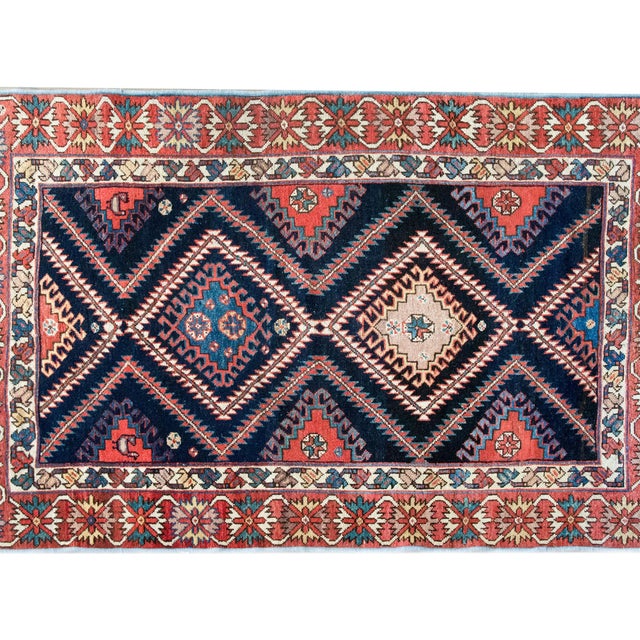This early 20th-century Persian Bakhtiari rug showcases the bold geometry and rich palette that define the finest tribal...