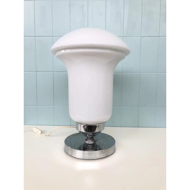 White glass table lamp and chromed steel base. Produced in Italy in the 70s European Plug (up to 250V).The wiring of this...