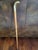 Vintage wooden walking cane with very detailed brass snake head. The cane is three pieces.