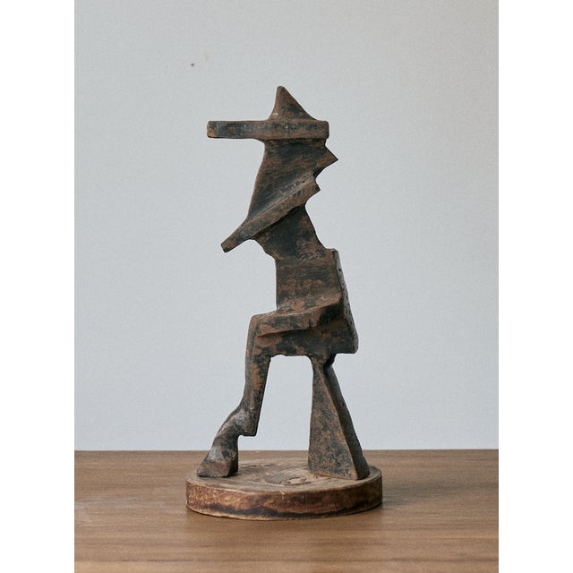 Vintage metal brutalist sculpture on round wood base. Great patina to the metal. The metal piece of this decorative...