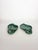 An elegant pair of glazed ceramic dishes, crafted in a stylized leaf shape with an integrated scroll handle. Their deep...
