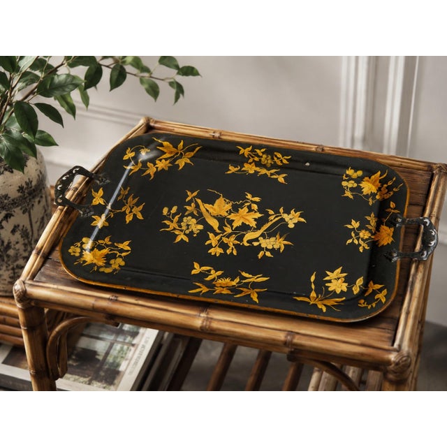 A lovely antique English black tole tray with a hand painted gold gilt birds and floral design, rolled rim, and charming...