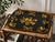 A lovely antique English black tole tray with a hand painted gold gilt birds and floral design, rolled rim, and charming...