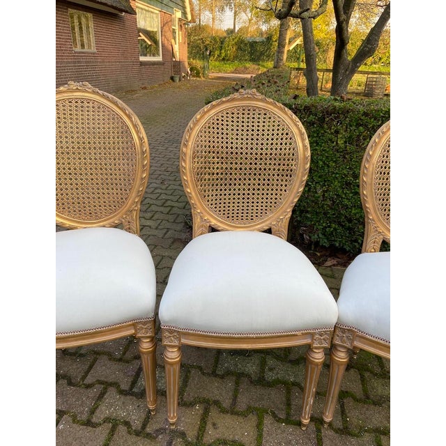 This coordinated set of four French dining chairs dates to the 1970s and presents the elegant proportions and classical...