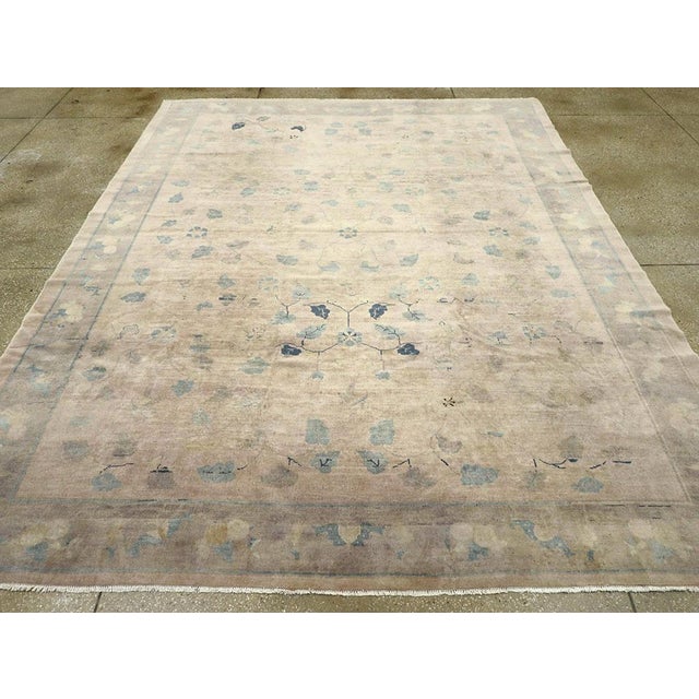 This mid-20th century Chinese Art Deco rug, features a refined and elegant floral design characteristic of the period’s...