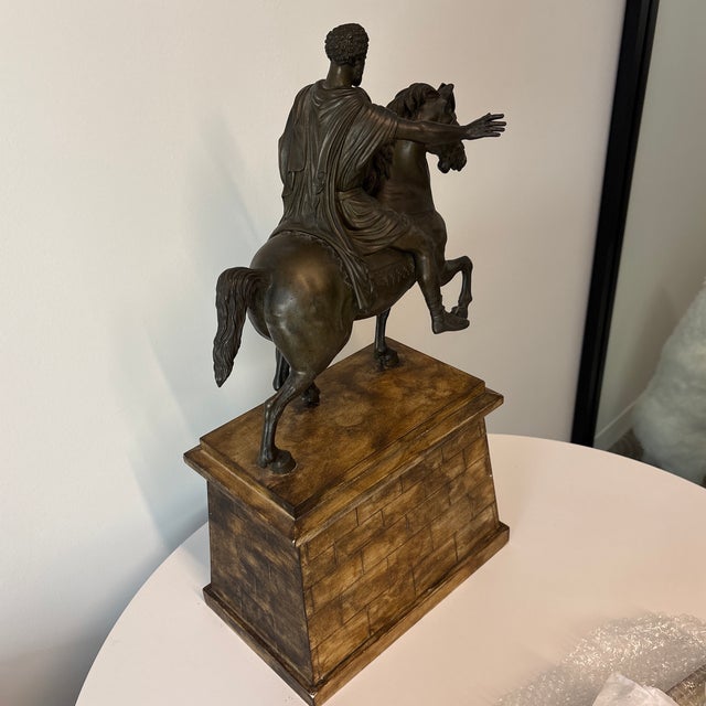 A Grand Tour Bronze Equestrian Model of Marcus Aurelius After the Antique, Late 19th Century mounted to a painted wood...