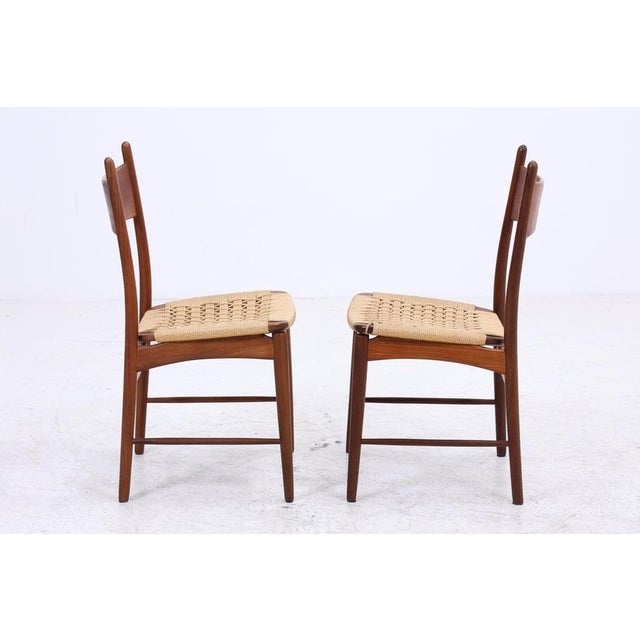Beautiful set of two vintage teak dining chairs from the 1960s with a clean, slender form and understated Danish lines....