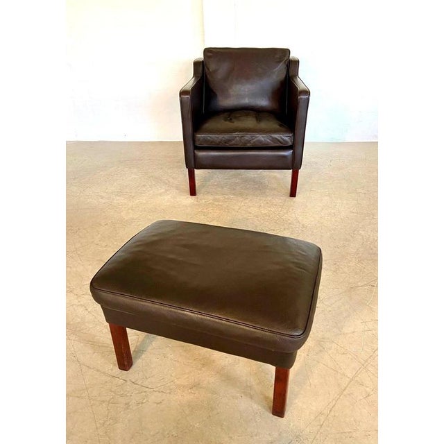 A superb vintage Scandinavian lounge chair and matching footstool by Danish manufacturer Stouby, dating from the 1970s and...