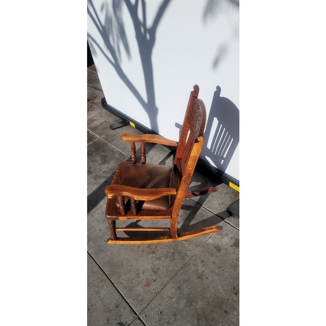 A very handsome childs rocker from the 1890s, Made of oak and nice oak construction with carving galore.