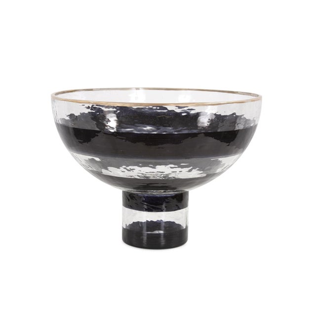 The Vector glass pedestal bowl features a hand painted black swirl pattern and a simple gold touch on the rim to complete...
