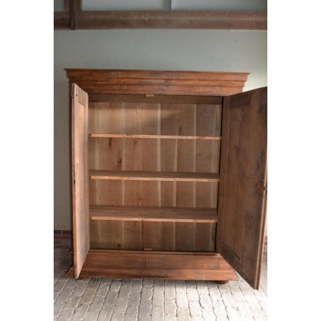 18th-century German oak cabinet. The height is 204 cm. The width is 166 cm. The depth is 57 cm. Partially removable....