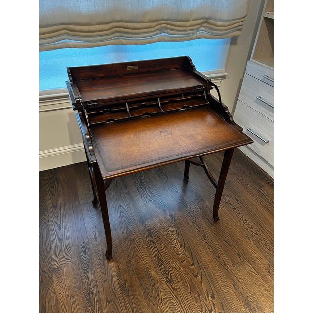 The Kaye campaign-style flip-top desk from Theodore Alexander combines classic brass campaign hardware with a rich leather...
