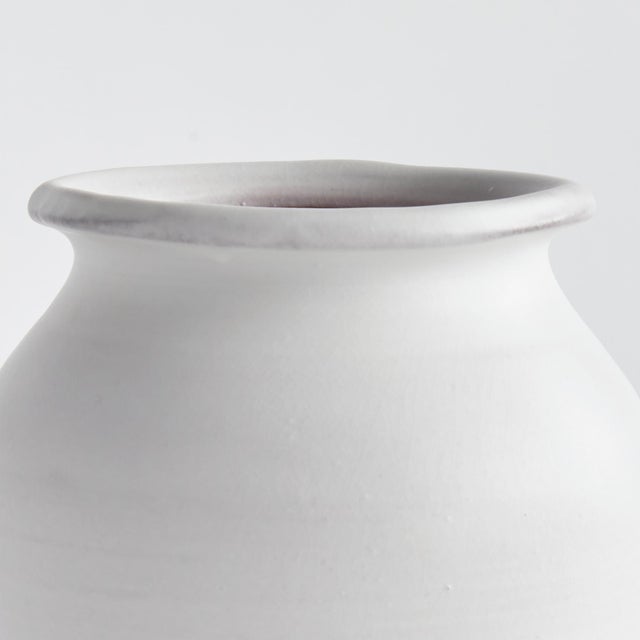 This handthrown terracotta drum vase is finished with a warmWhite glaze and has visible throw lines which only add to its...