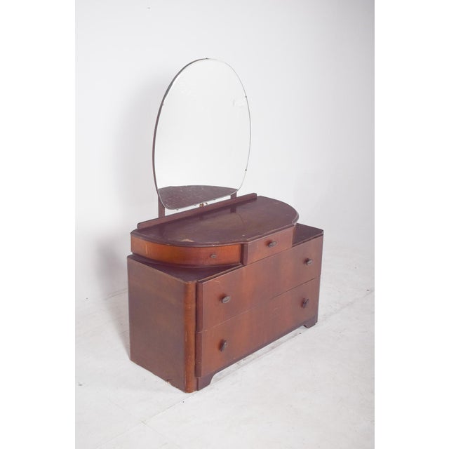 Art Deco walnut dressing table. with an imposing circular mirror resting on a discreet moulded structure, it reinforces...