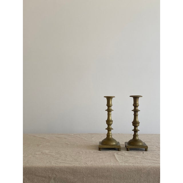A substantial and stylish pair of first half of the 19th century brass candlesticks. These candlesticks are solid brass...