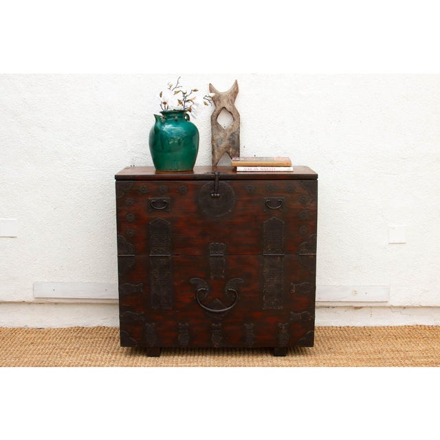 Crafted during the late Joseon Dynasty, this Antique Korean Bandaji is a monumental storage chest that balances powerful...