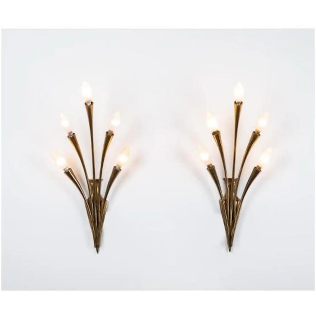 This pair of 1950s Mid-Century Modern wall sconces represents a masterful collaboration between renowned designer Oscar...