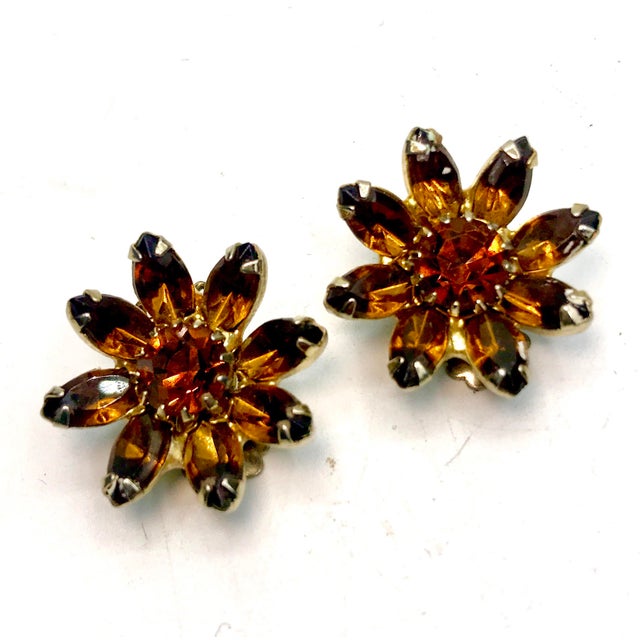 This is part of Chairish’s Costume Jewelry assortment. 1950s Weiss Crystal Flower clip on earrings. The crystals are in...