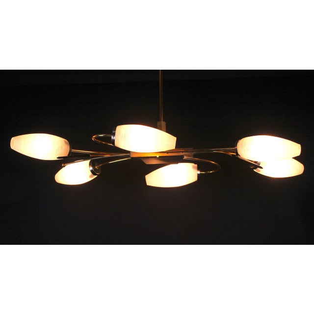 Classic and Elegant Mid-Century brass chandelier, with six beautiful white opaline shades, and two black spears. It fits...