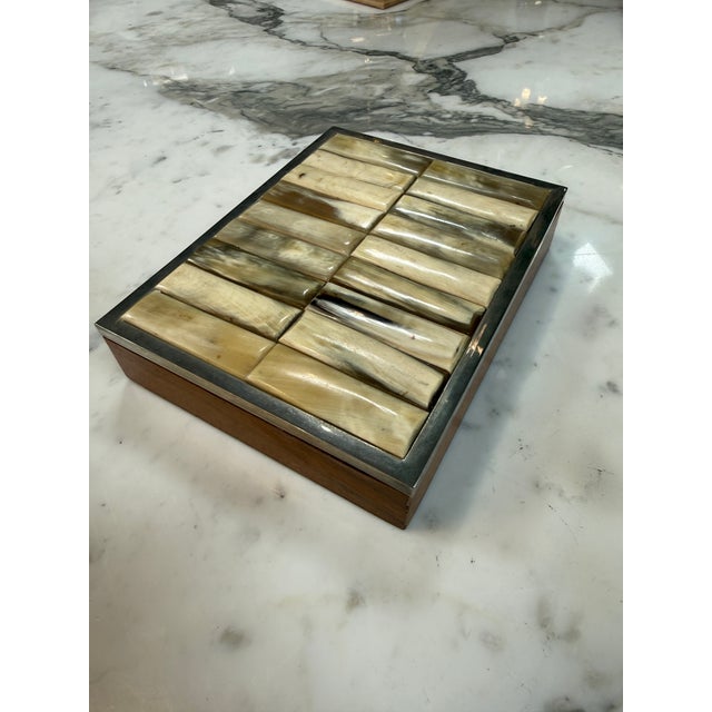 Distinctive vintage decorative box featuring a striking tessellated horn tile lid framed in polished metal over a warm...