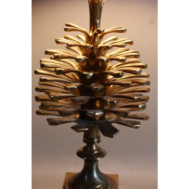 Charles pine cone lamp. This 1970s lamp is made of gilded bronze and has its original gilded metal shade. The shade shows...
