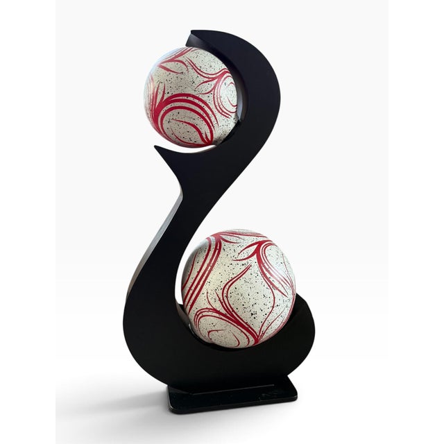 Striking vintage 1970s sculptural table lamp featuring a dramatic black S-form silhouette supporting two spherical shades....