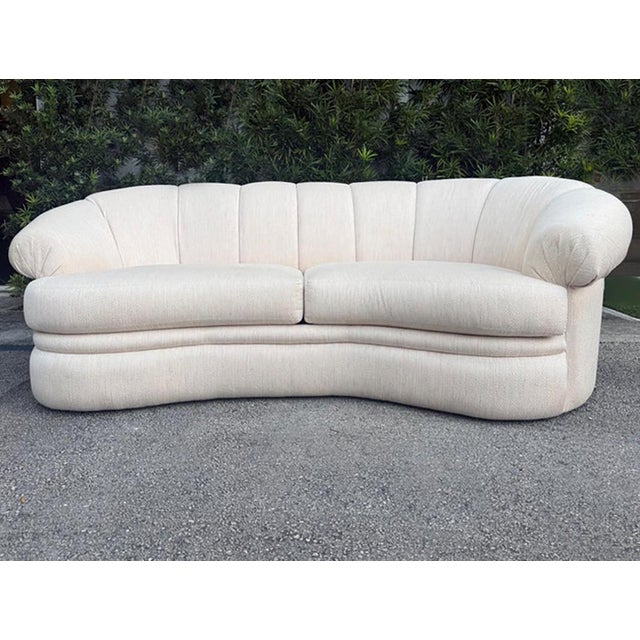 A 1980s vintage asymmetric curved sofa by Thayer Coggin. The sofa is back-channelled and is lower on the left end as you...
