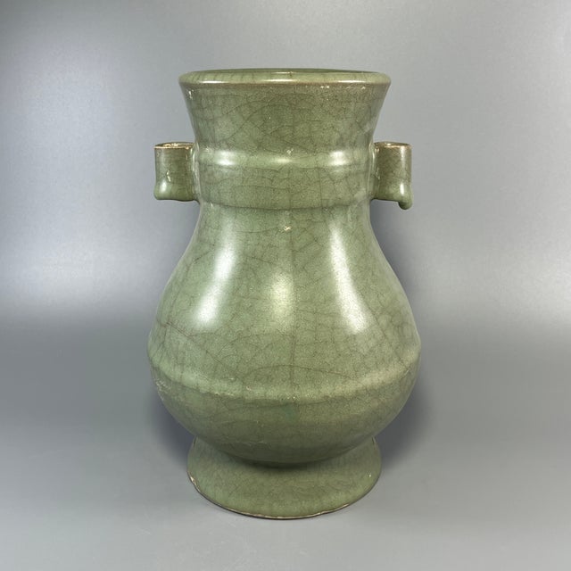 A vintage‑style Chinese Longquan celadon arrow vase, also known as guan‑er vase, with two pierced tubular handles on both...